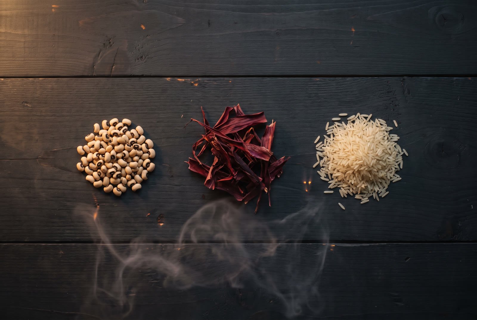 Black-eyed peas, dried sorghum leaves and rice on dark wood